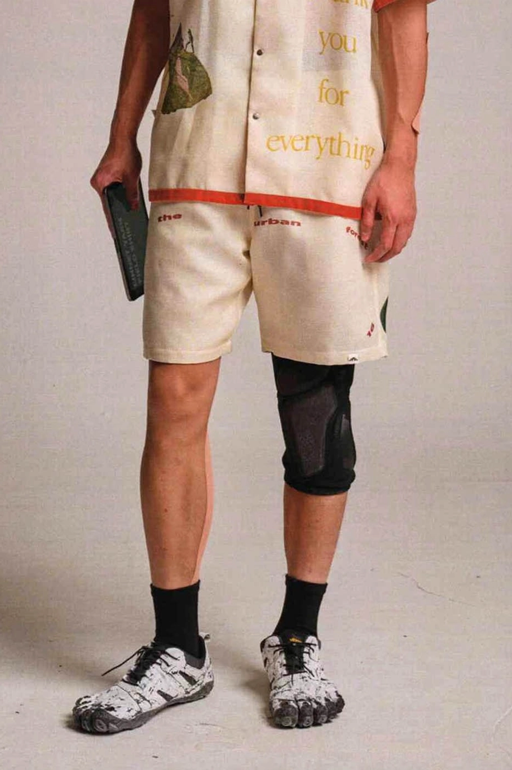 Urban Forest graphic sweat shorts fashion detail showing urban typography and relaxed summer styling