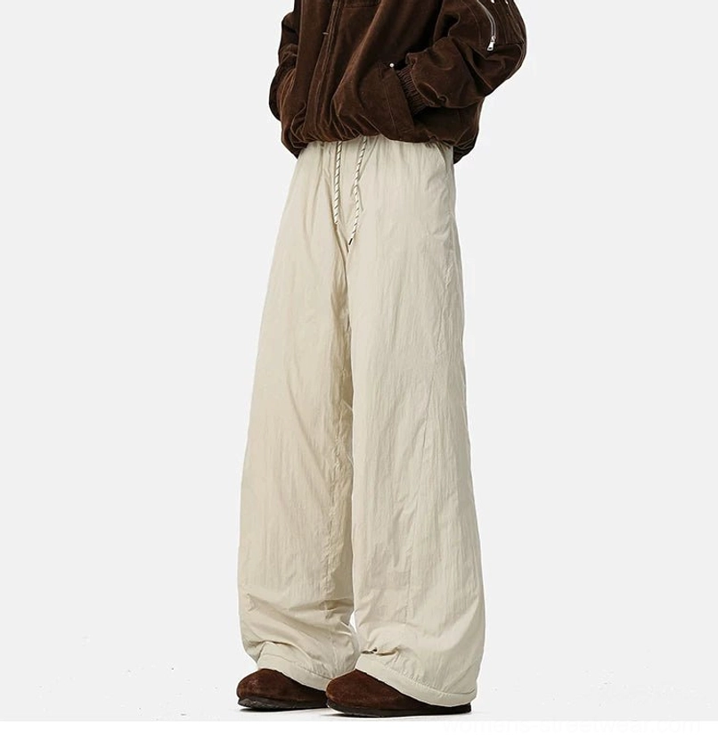 Urban winter wide-leg pants with textured polyester shell, fleece lining, and relaxed streetwear proportions