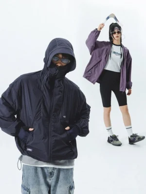 Two models wearing black UV-protective hooded windbreaker with full face cover and slip pockets in studio setting