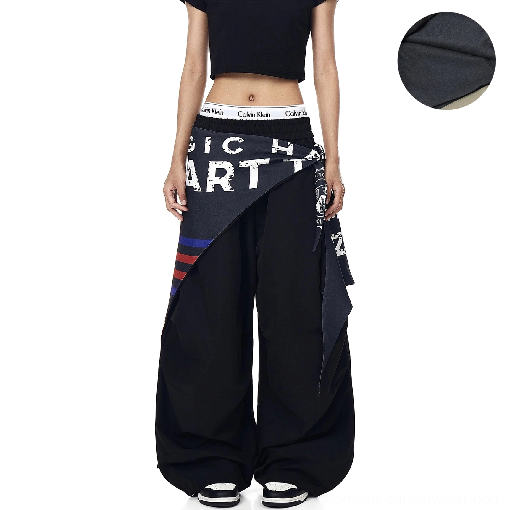 Black fleece-lined varsity scarf parachute cargo pants with an oversized wide-leg fit, elastic waistband, and layered streetwear scarf detail