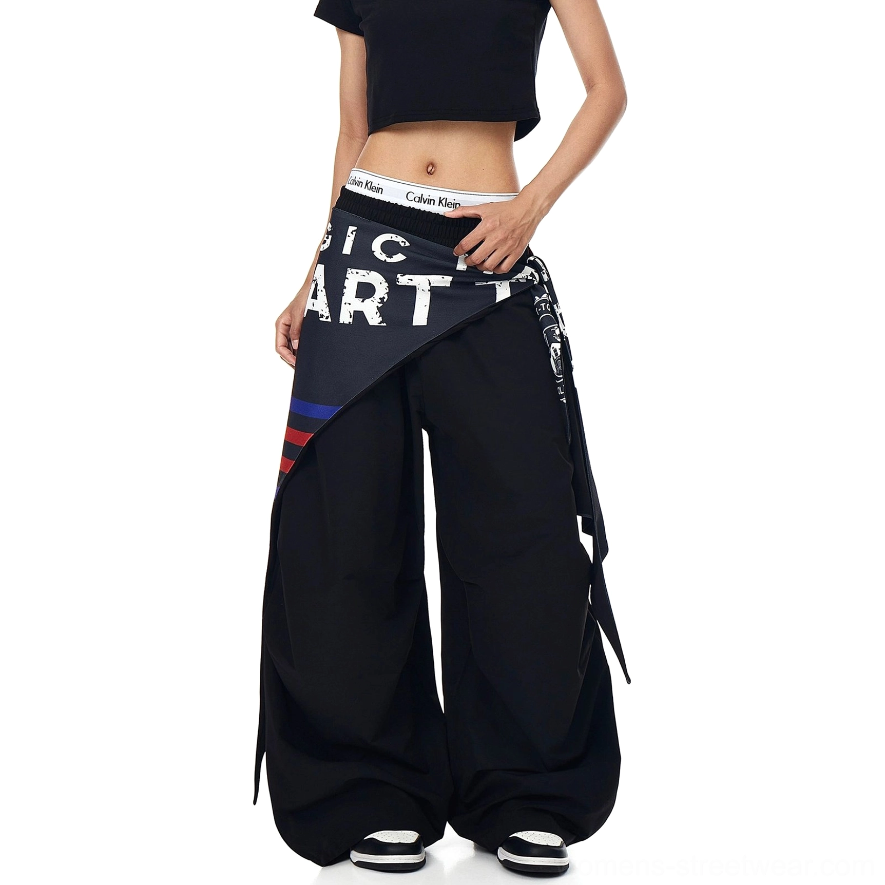 Oversized streetwear cargo pants featuring a sculptural parachute silhouette, relaxed elastic waistband, and asymmetric varsity fashion detail