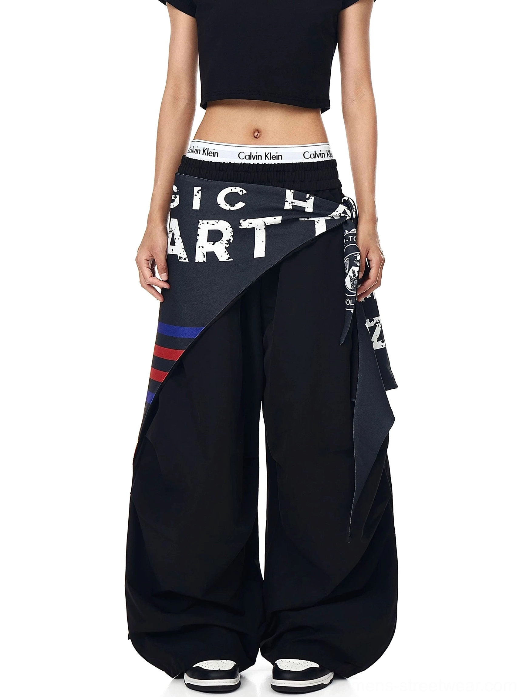 Varsity scarf parachute cargo pants product detail showing the oversized streetwear fit, wide-leg cargo shape, and layered scarf styling