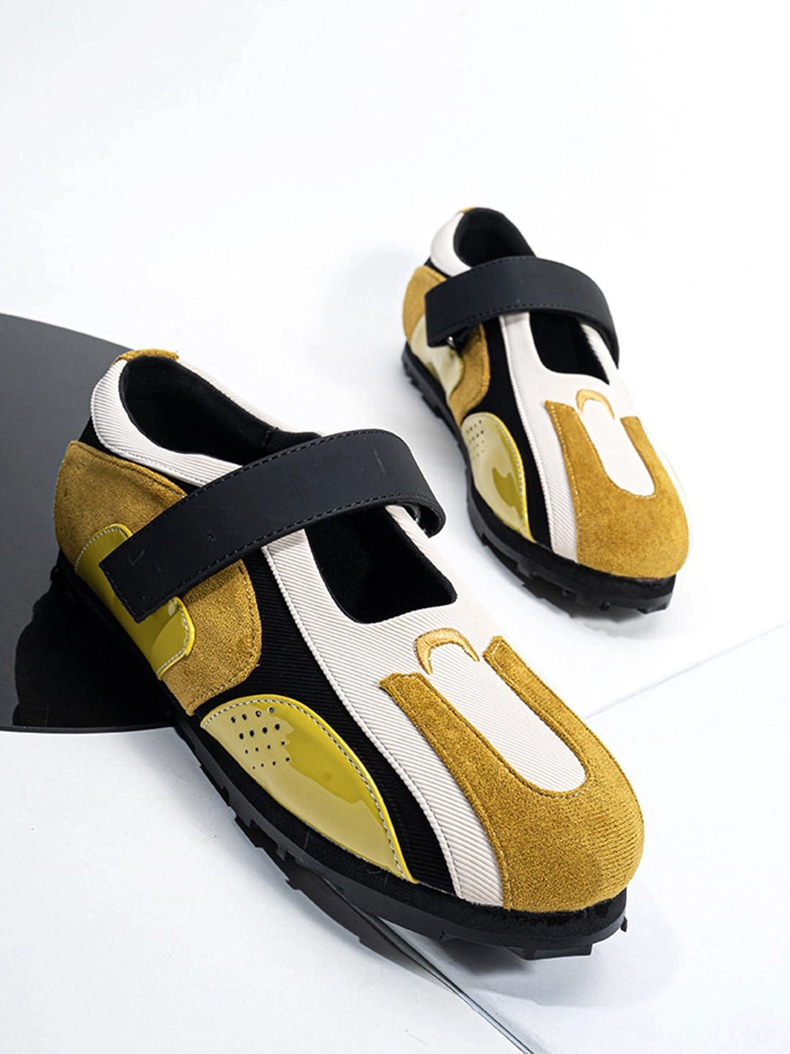 Close-up of yellow and black sport ballet Mary Jane sneaker showing wide Velcro strap and mixed-material upper