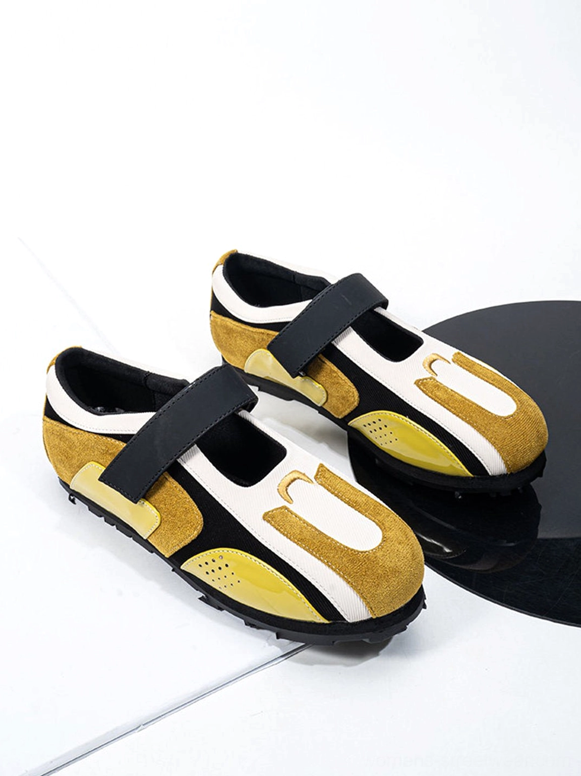 Pair of yellow black and off-white sport ballet Mary Jane sneakers shown from above in studio