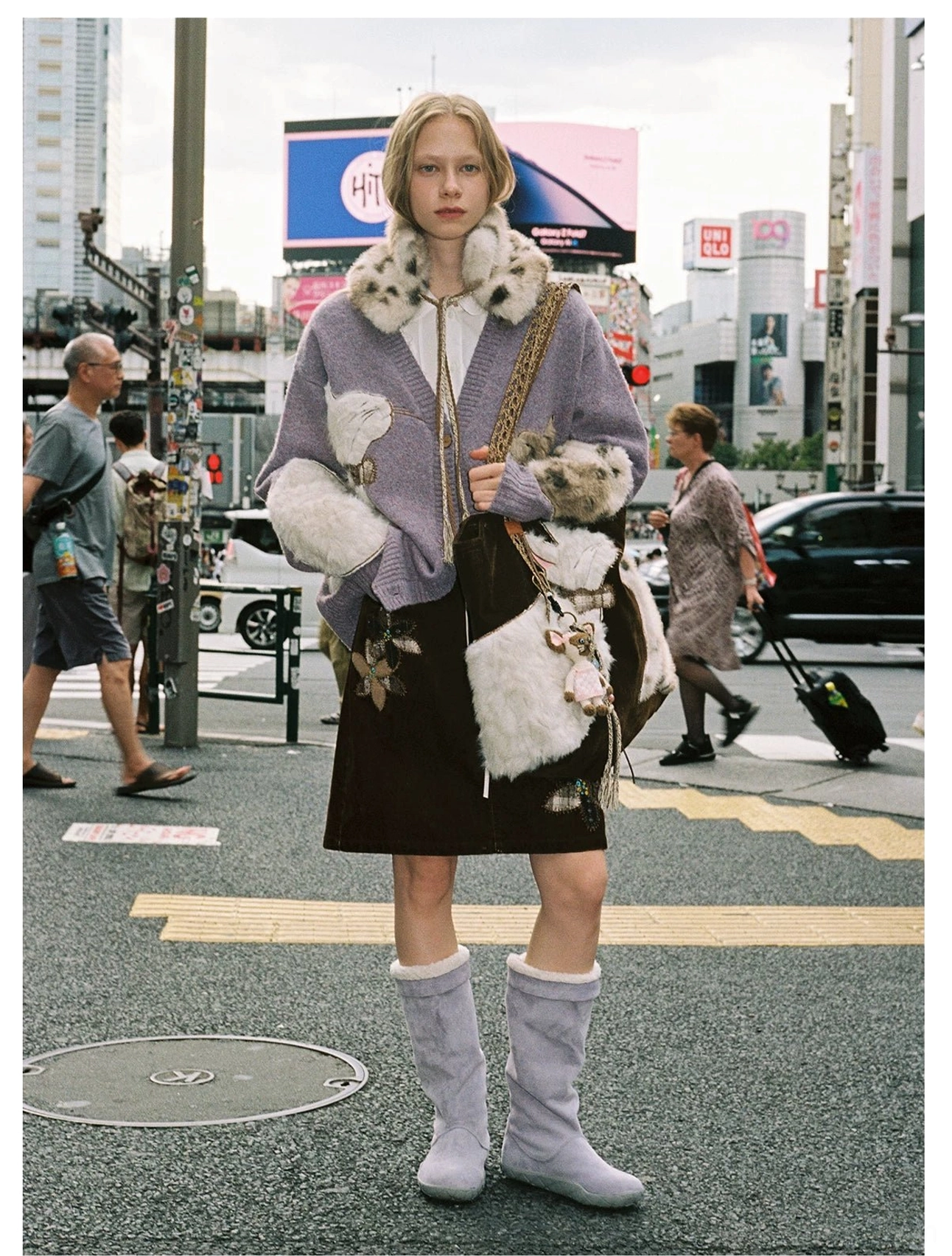 Velvet cat plush tote bag styled with a fur collar cardigan, corduroy skirt, lavender boots, and downtown streetwear