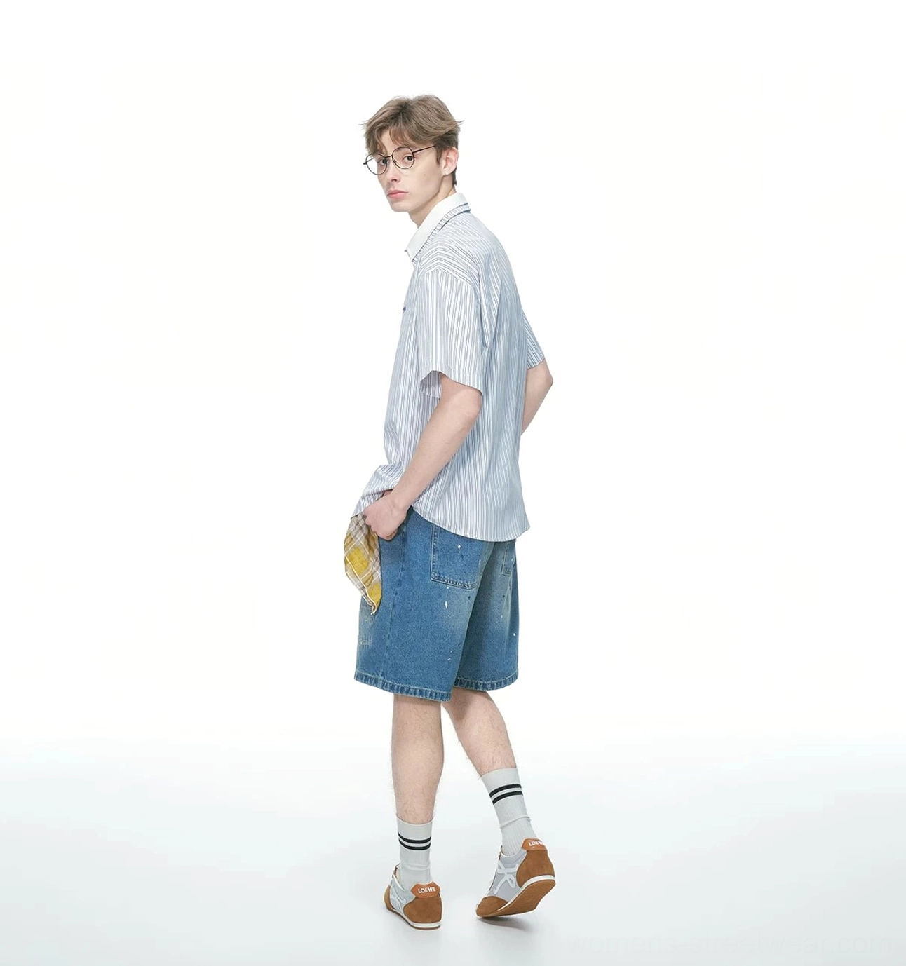 Vertical pinstripe short sleeve streetwear shirt with relaxed fit styled with denim shorts striped socks and leather loafers