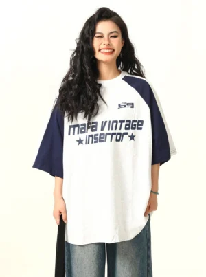 Gray and navy vintage 69 graphic oversized raglan t-shirt front view styled with wide-leg jeans