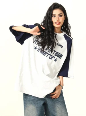 Oversized gray and navy raglan graphic t-shirt three-quarter front view with vintage sportswear styling