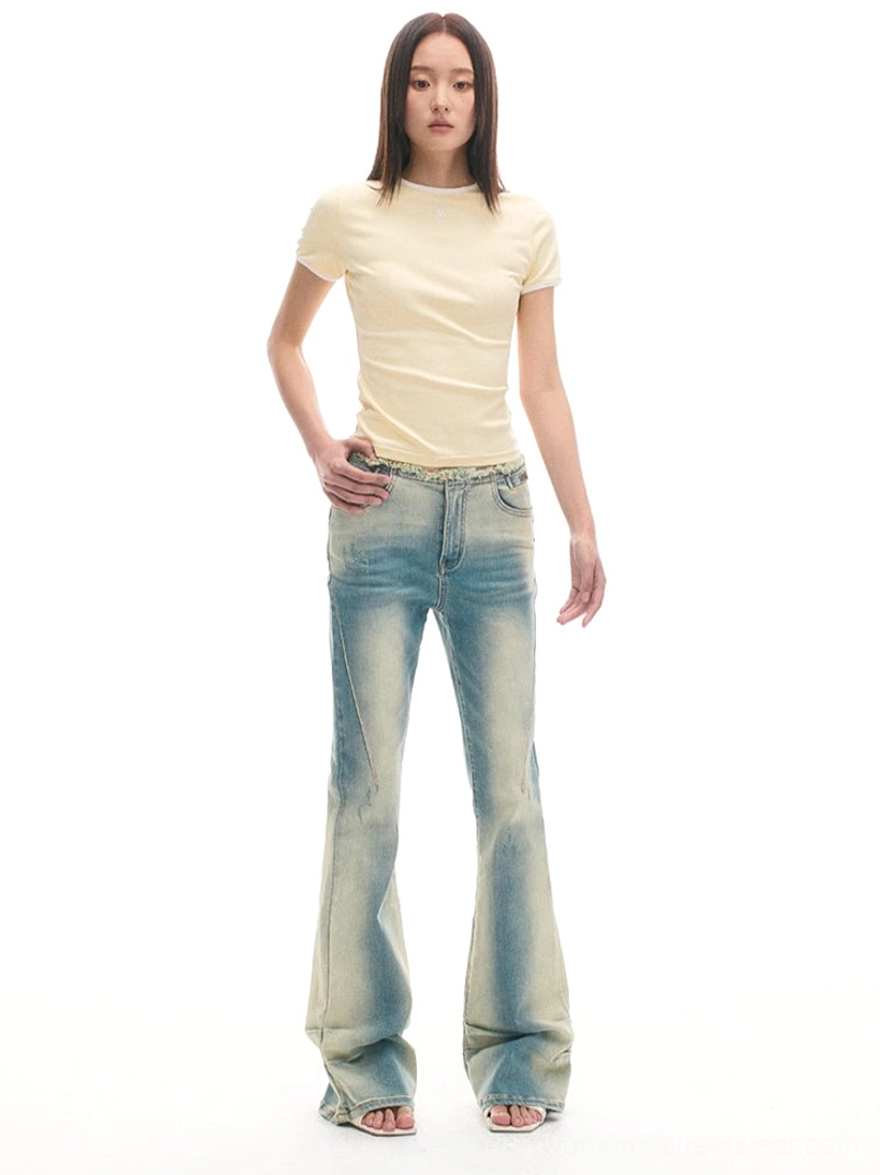 Vintage acid wash flared denim jeans shown in a front three-quarter view with classic pockets and faded finish