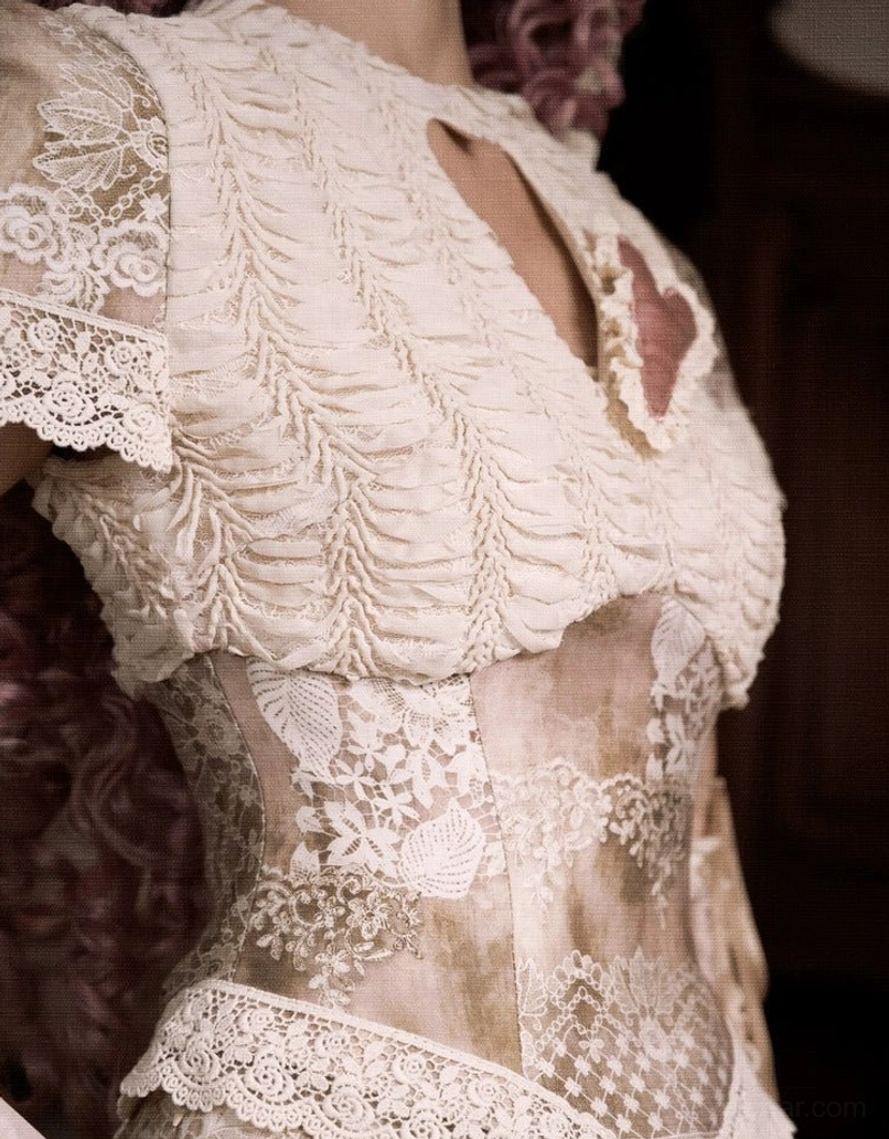 Vintage lace heart cutout corset top in romantic beige and taupe streetwear styling with feminine patchwork texture and fitted silhouette