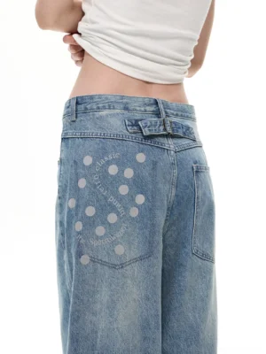 Close-up back view of vintage blue balloon wide leg boyfriend jeans with adjustable waistband and dot print pocket detail