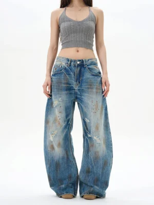 Front view of women's vintage blue distressed wide-leg jeans with high waist, ripped denim details, and relaxed Y2K streetwear silhouette