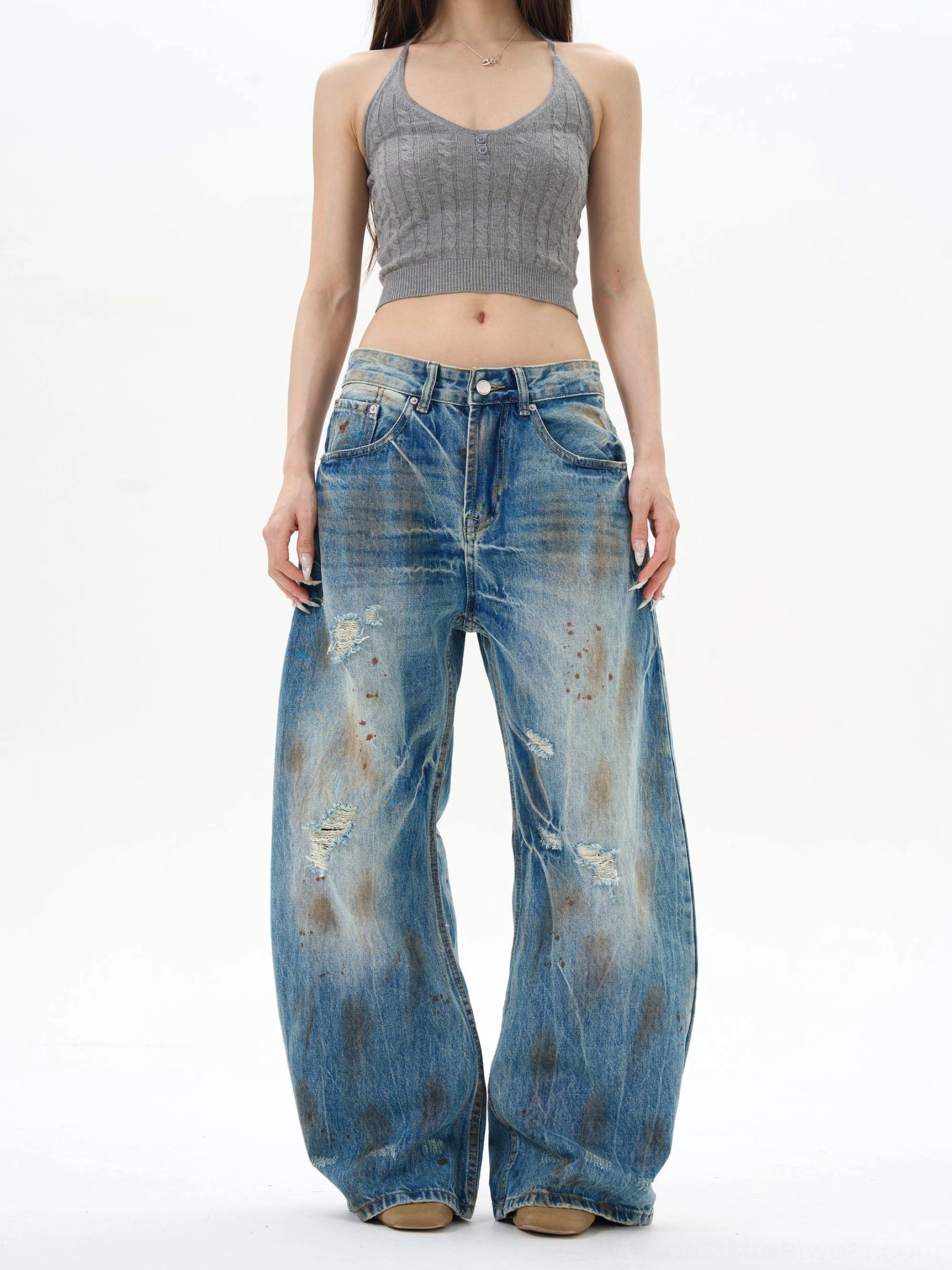 Front view of women's vintage blue distressed wide-leg jeans with high waist, ripped denim details, and relaxed Y2K streetwear silhouette