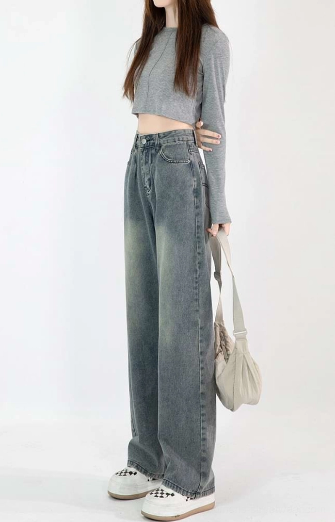 Right side view of faded vintage blue wide-leg jeans showing the relaxed thigh fit, tailored waistband, and full-length silhouette