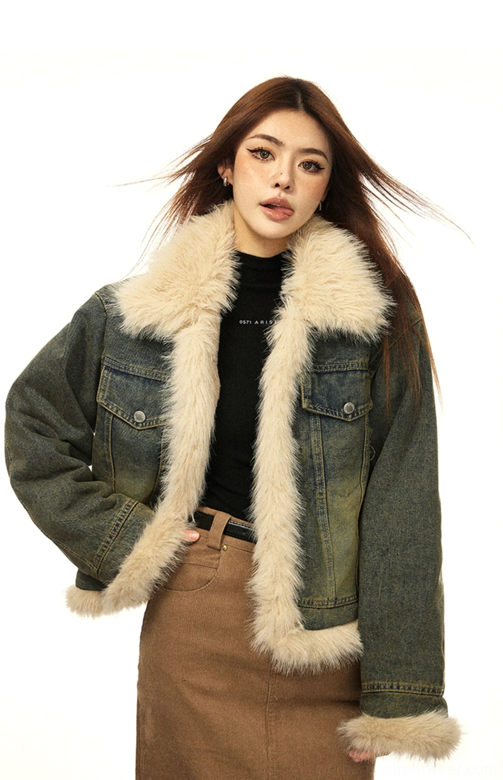 Woman wearing a vintage blue faux fur lined denim winter jacket in a front three-quarter studio view with beige fur collar cuffs and hem