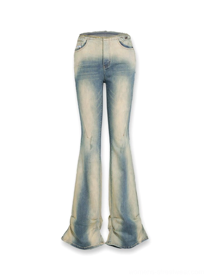 Vintage blue low-rise flared denim jeans with high-stretch fabric, raw waistband, and full-length Y2K silhouette