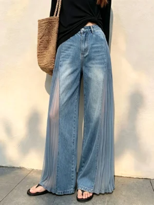 Front full view of vintage blue sheer panel wide-leg jeans with pleated mesh side inserts and high-waisted streetwear fit