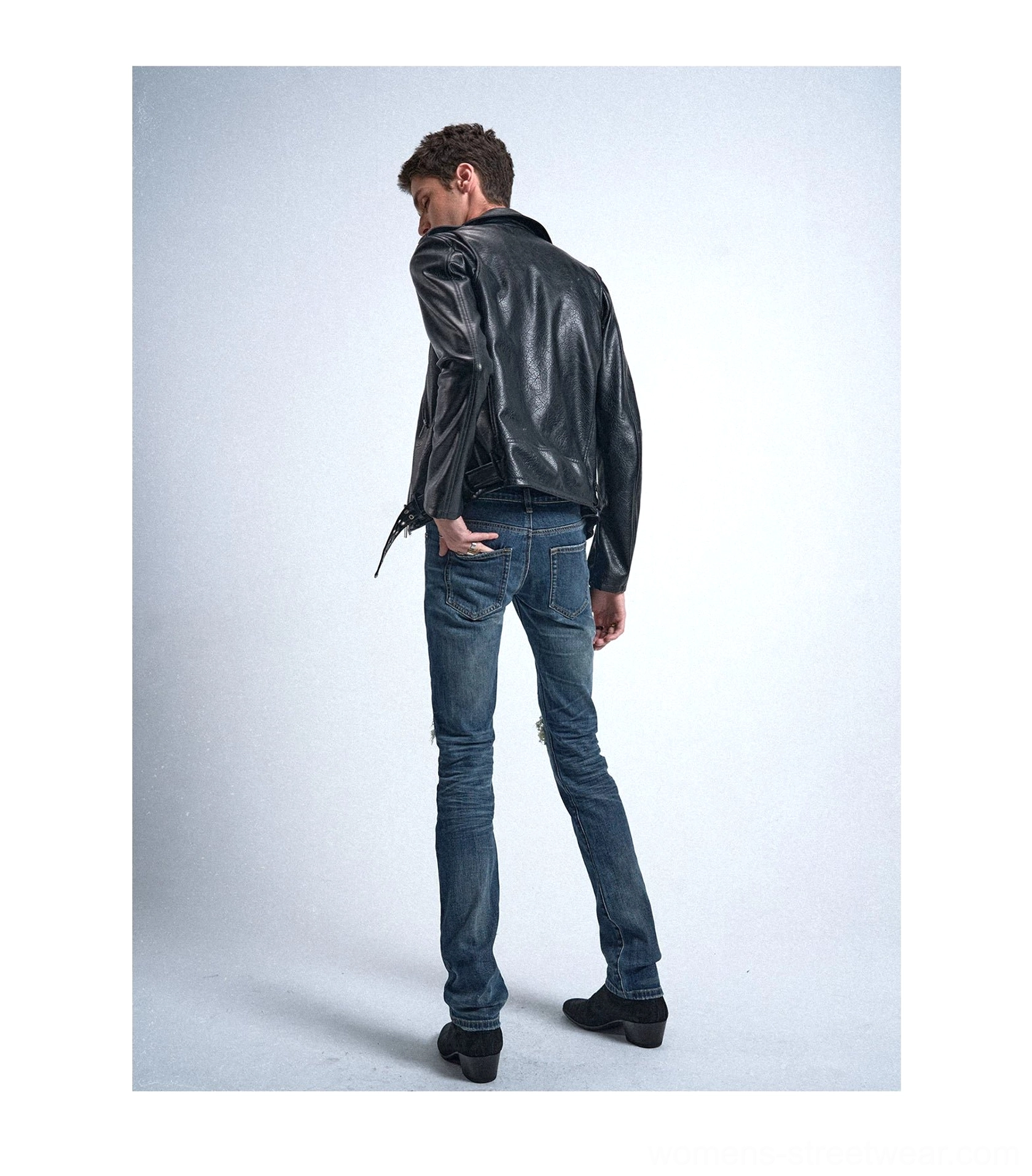 Rear view of vintage blue slim tapered jeans showing the fitted silhouette, faded wash, and clean tapered hem