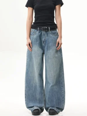 Front full-body view of vintage blue ultra-wide baggy jeans styled with a black fitted tee in a Korean streetwear silhouette