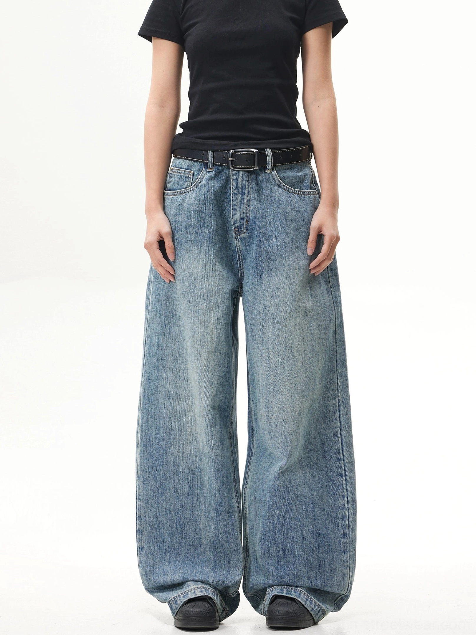 Front full-body view of vintage blue ultra-wide baggy jeans styled with a black fitted tee in a Korean streetwear silhouette