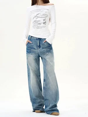 Female model wearing vintage blue wash high-waisted wide-leg jeans in a relaxed streetwear outfit, front full-body view