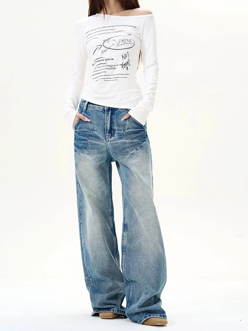 Female model wearing vintage blue wash high-waisted wide-leg jeans in a relaxed streetwear outfit, front full-body view
