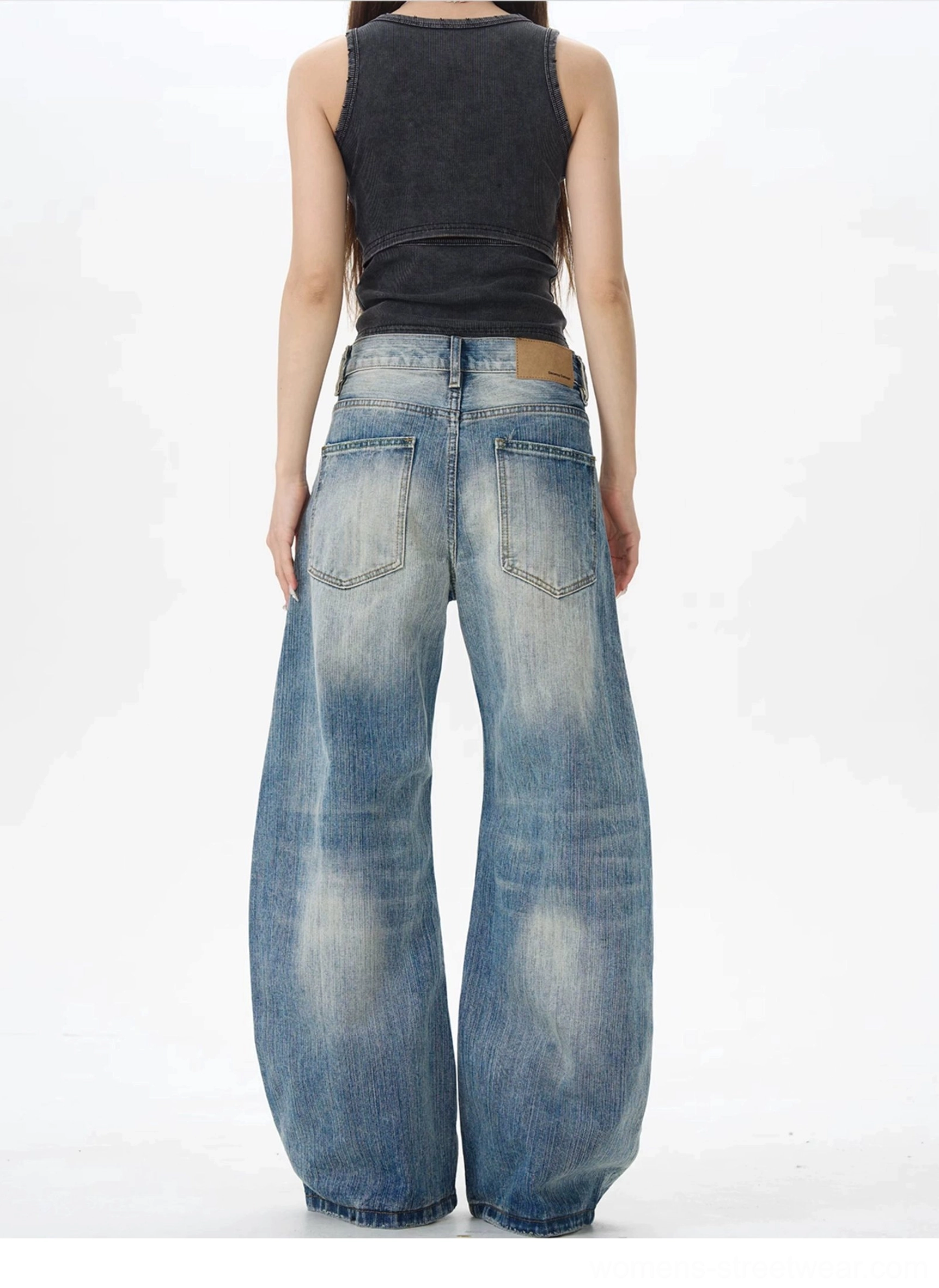Vintage blue wide leg jeans rear view showing faded wash back pockets and leather waist patch