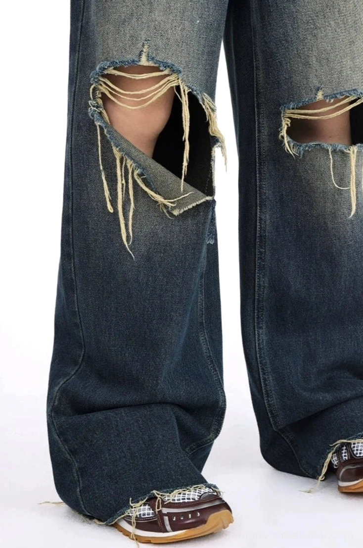 Vintage blue wide leg ripped jeans featuring a high-waisted fit, dark gradient denim wash, oversized frayed knee details, and relaxed Korean streetwear styling