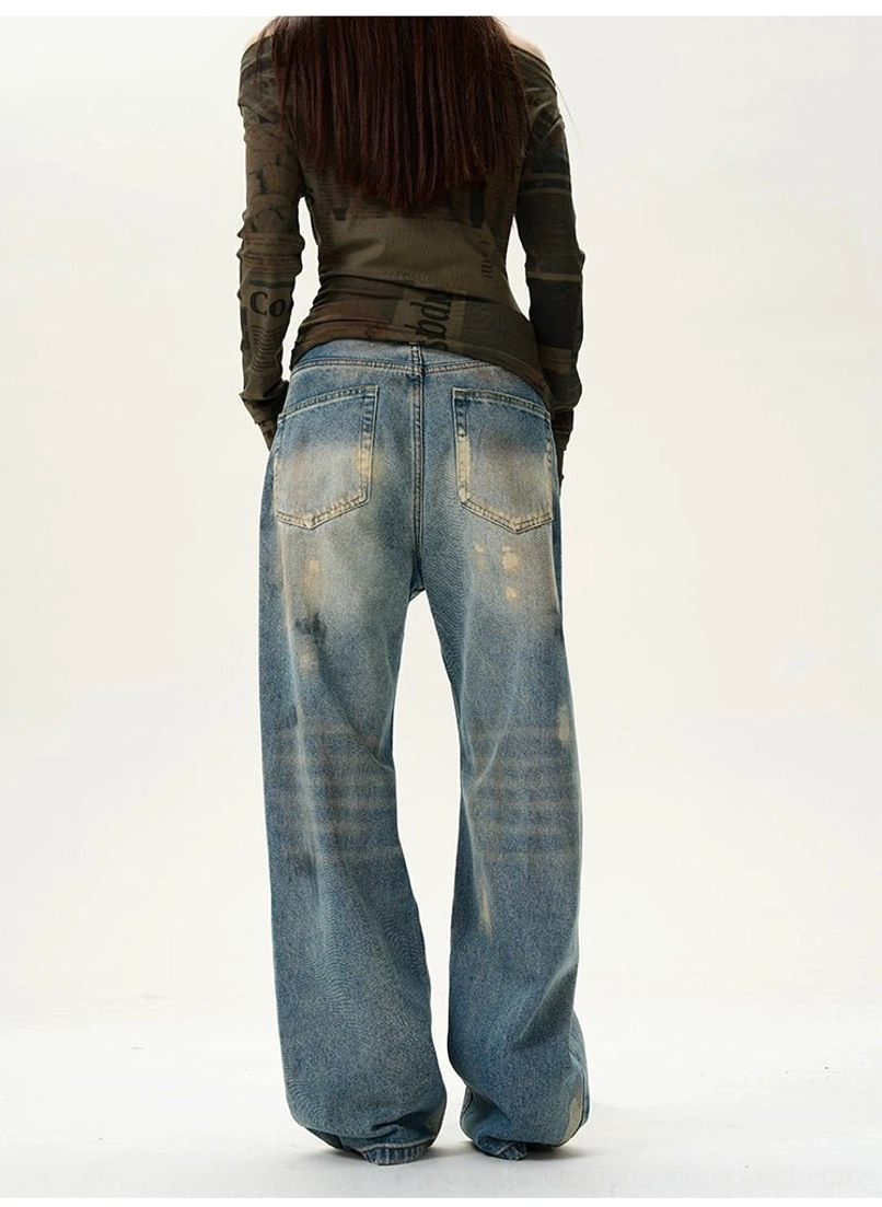 Rear view of vintage blue wide-leg streetwear jeans with two patch pockets, faded denim panels, and brown distressed detailing