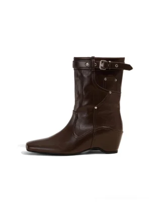 Vintage brown buckle-cuff western ankle boot with low wedge heel and metal rivet details front left view