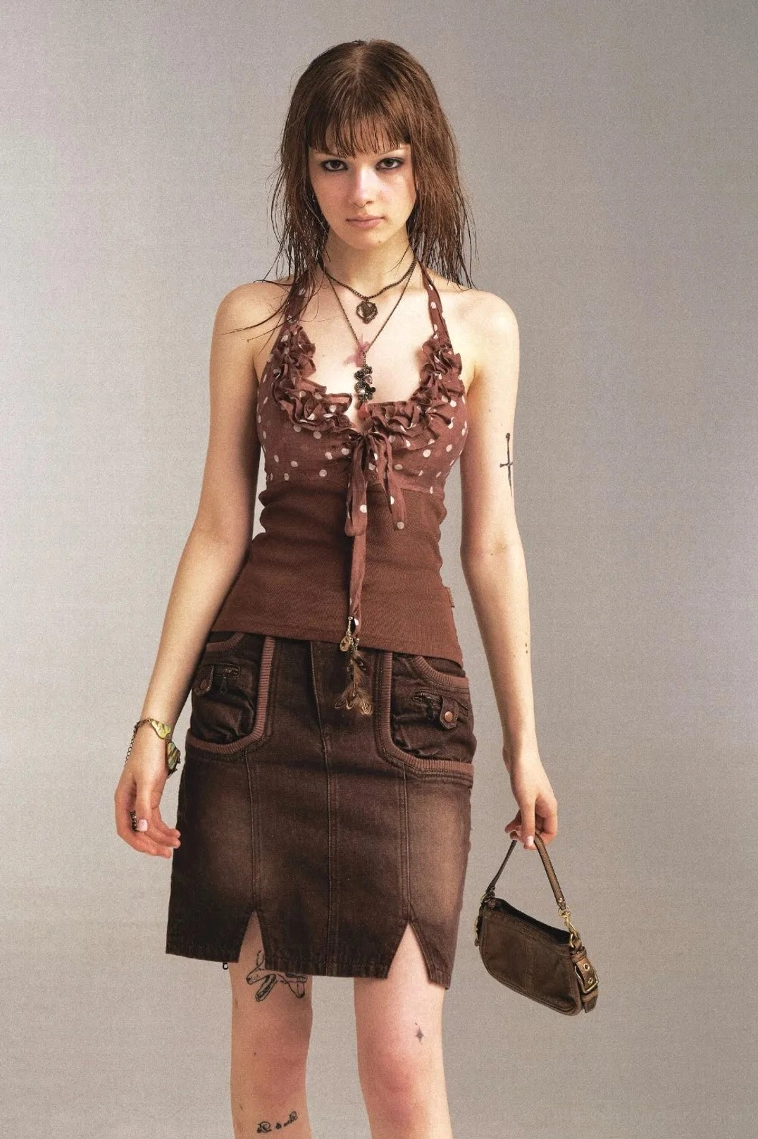 Full front view of womens vintage brown denim pencil skirt with low waist, front pockets, and slit