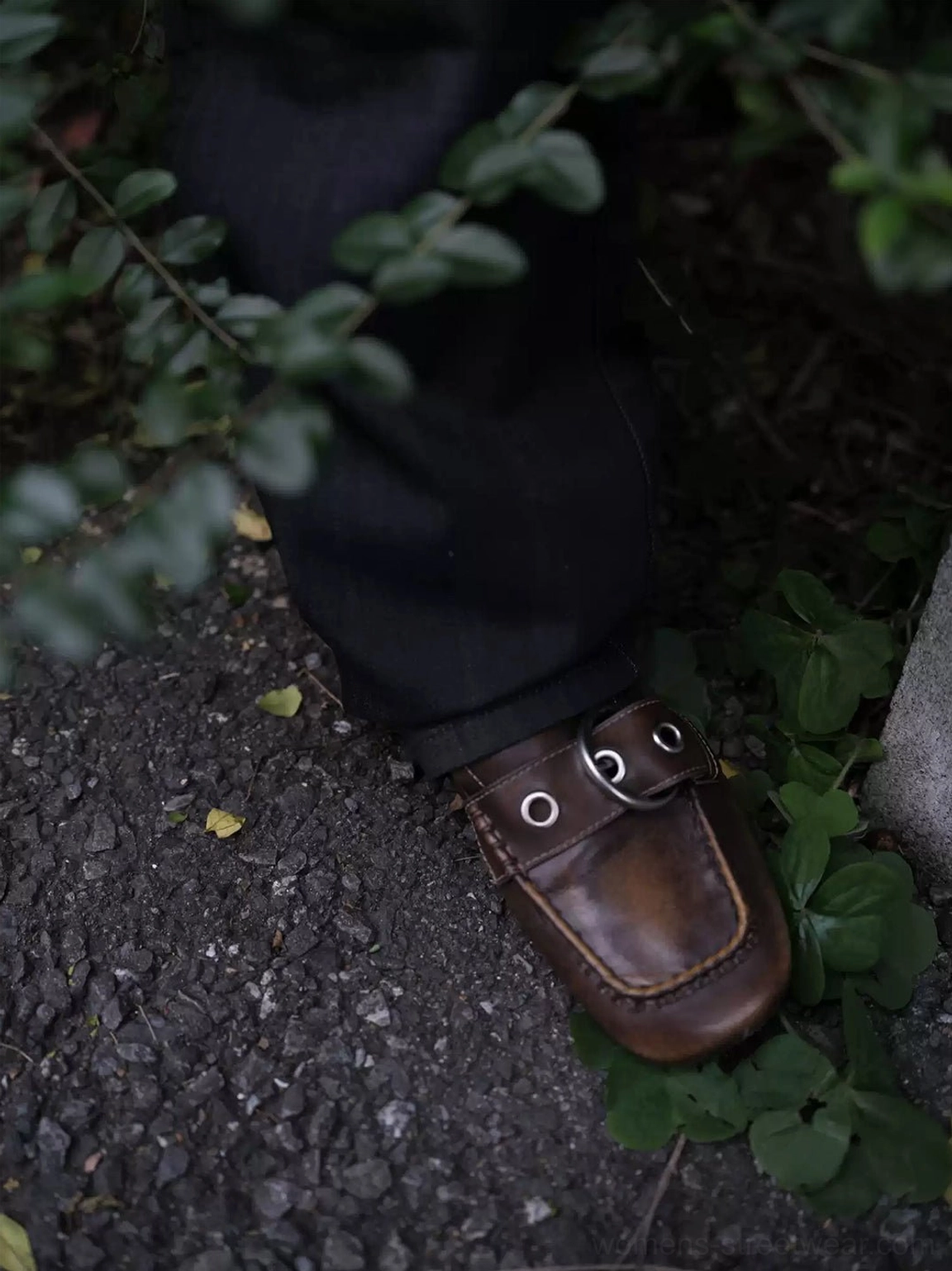 Close-up of vintage brown ruched buckle flat showing twin metal ring buckles, stitched vamp, and aged finish
