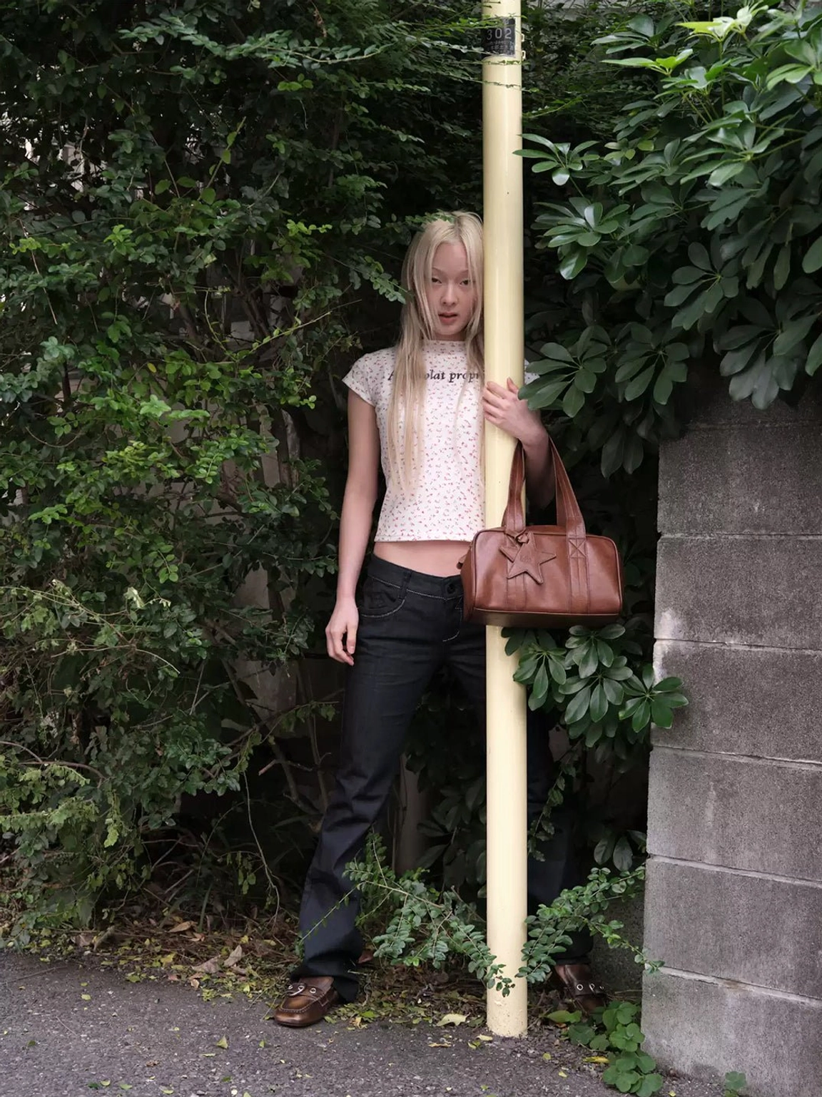 Vintage brown ruched buckle flats in outdoor streetwear styling with brown leather tote bag