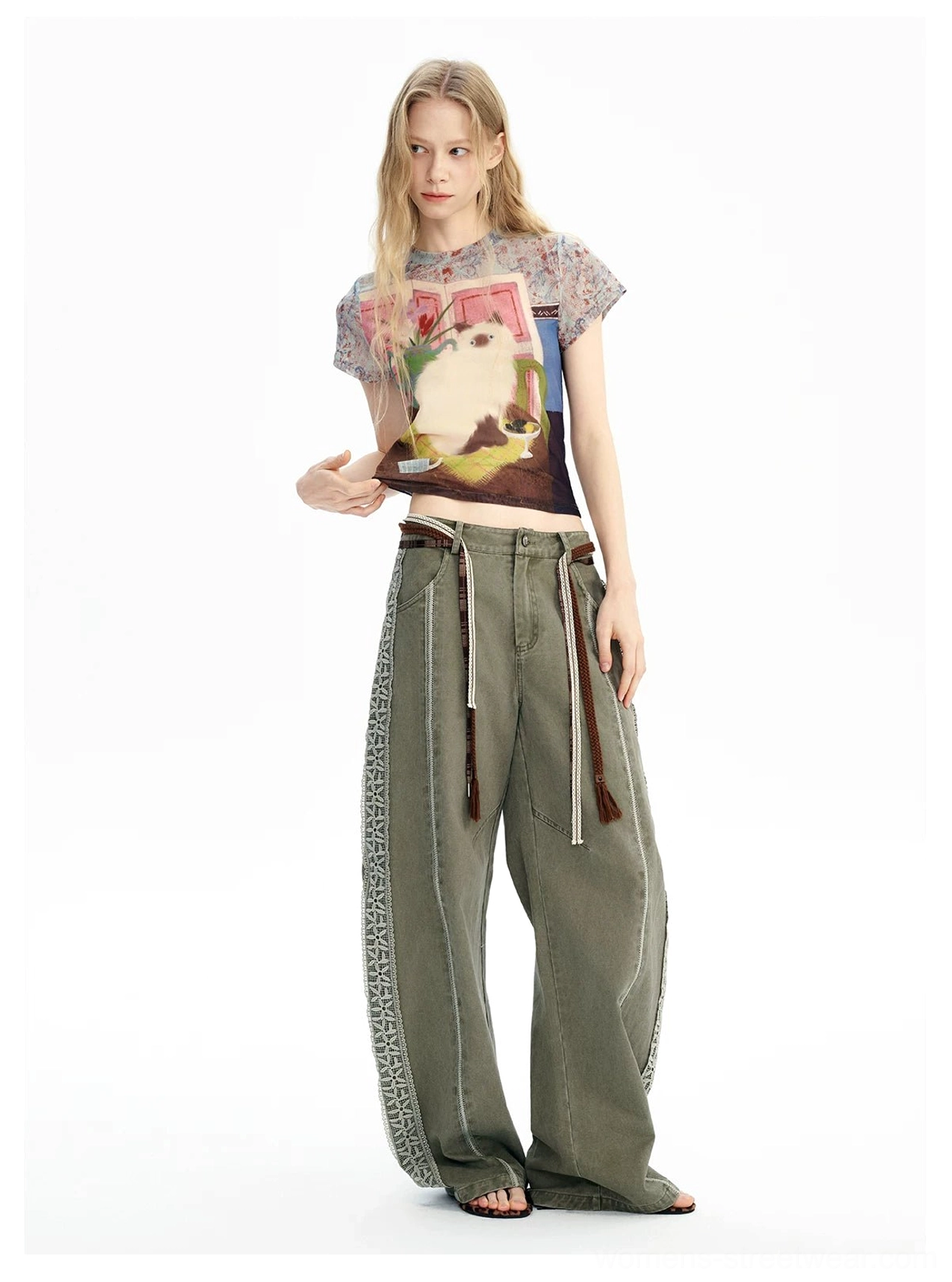 Side view of vintage cat dreamscape mesh graphic baby tee with relaxed olive wide leg pants