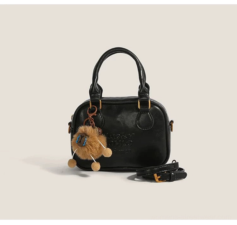 Black vintage cub charm mini satchel crossbody bag for streetwear with plush pendant and gold-tone hardware