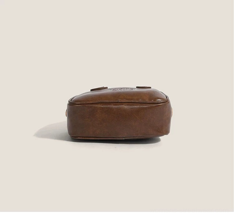 Bottom view of vintage brown PU mini satchel crossbody streetwear bag with compact rectangular base