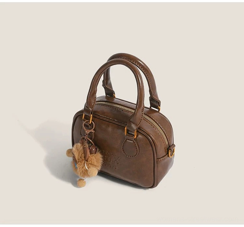 Vintage brown cub charm mini satchel crossbody bag with double top handles, gold hardware and zippered opening