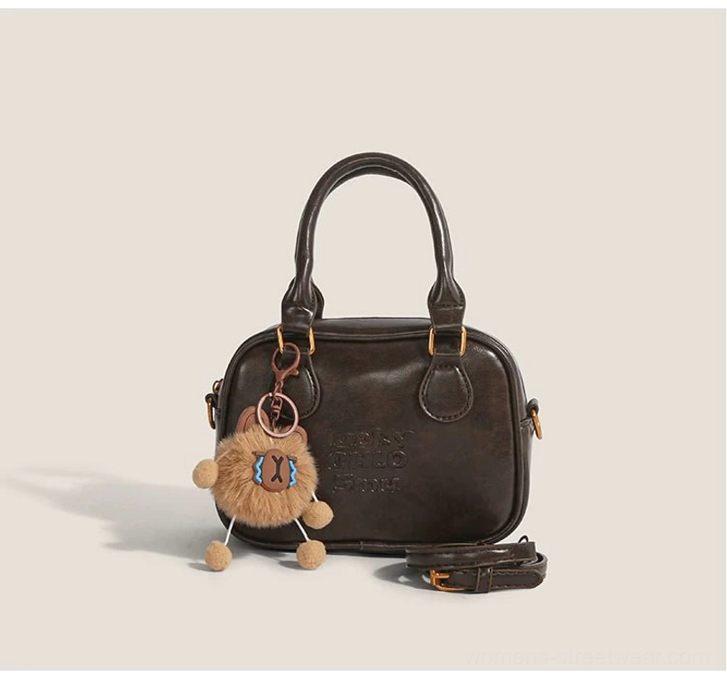 Coffee brown vintage cub charm mini satchel crossbody bag for streetwear with plush pendant and gold hardware