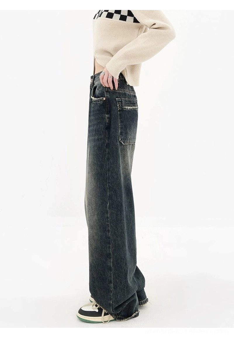Vintage dark blue wide-leg denim jeans side rear full-body view with relaxed streetwear proportions