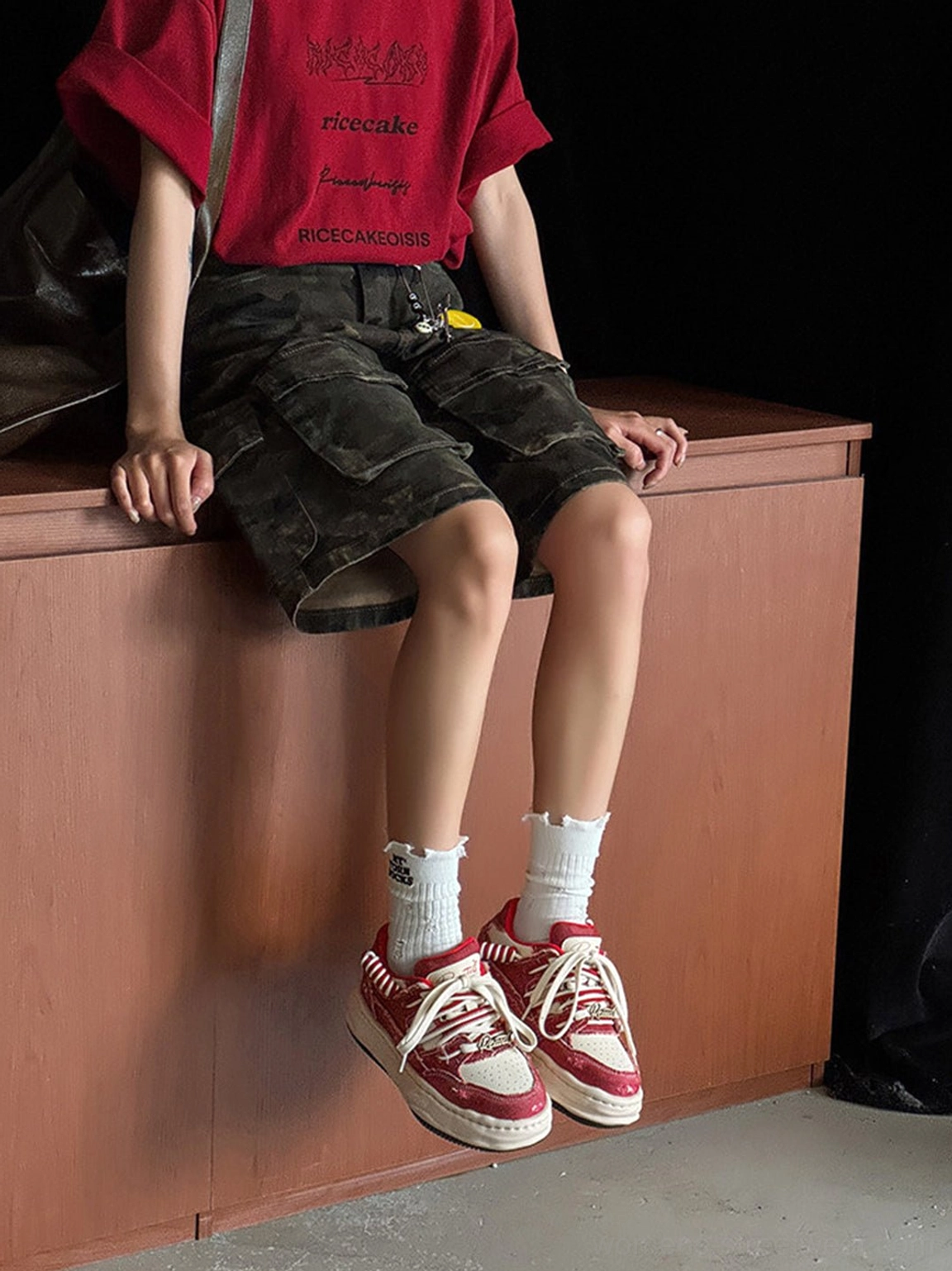 Vintage denim-effect platform sneakers worn with camo cargo shorts and a cropped top for a relaxed casual street style