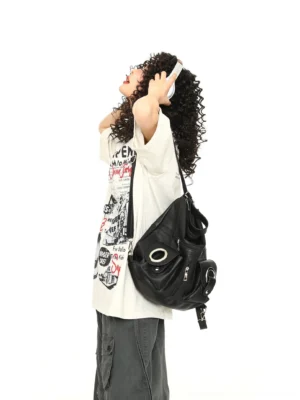 Off-white vintage diner graphic tee shown from a side rear angle with cargo pants headphones and black shoulder bag