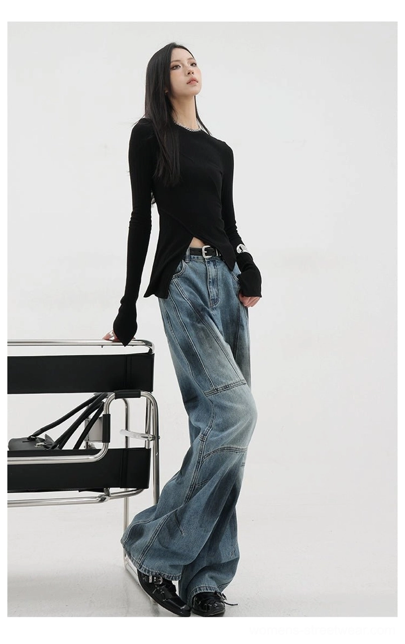 Vintage distressed wide-leg jeans detail photograph of blue non-distressed style showing cleaner silhouette with vintage wash finish without aggressive ripped areas