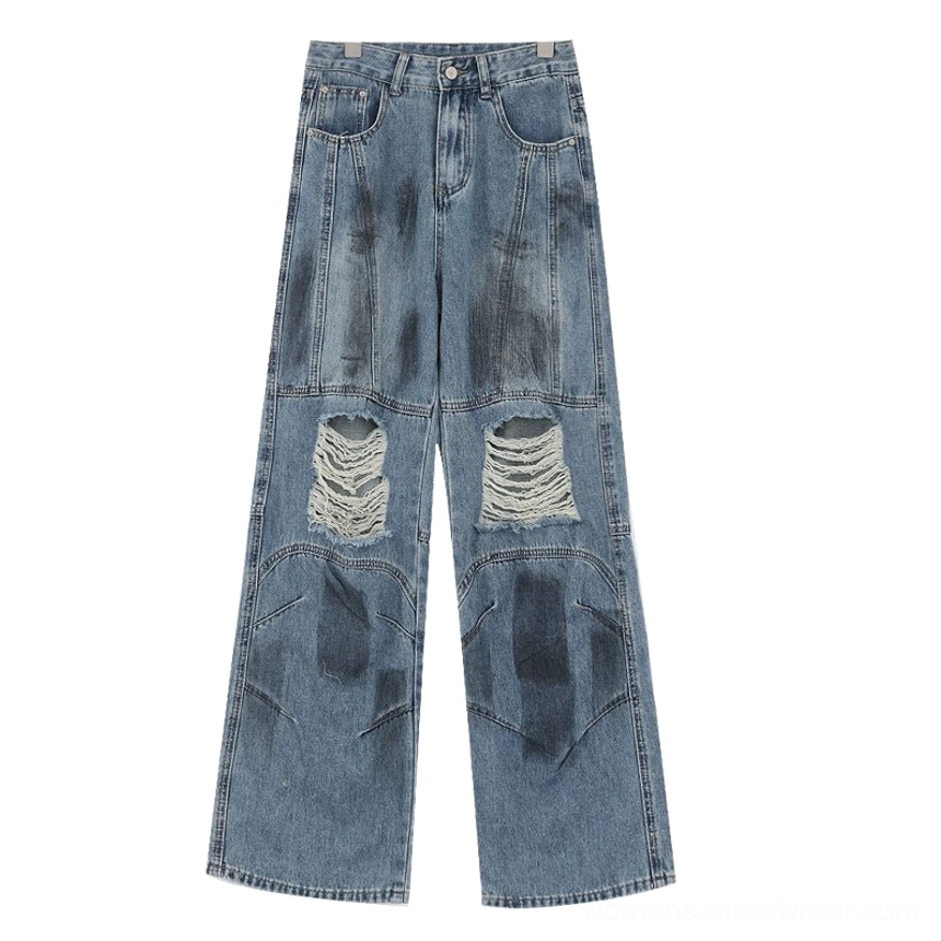 Vintage distressed wide-leg jeans blue distressed style close-up detailed view of specific ripped destruction points and faded finish variation characteristic