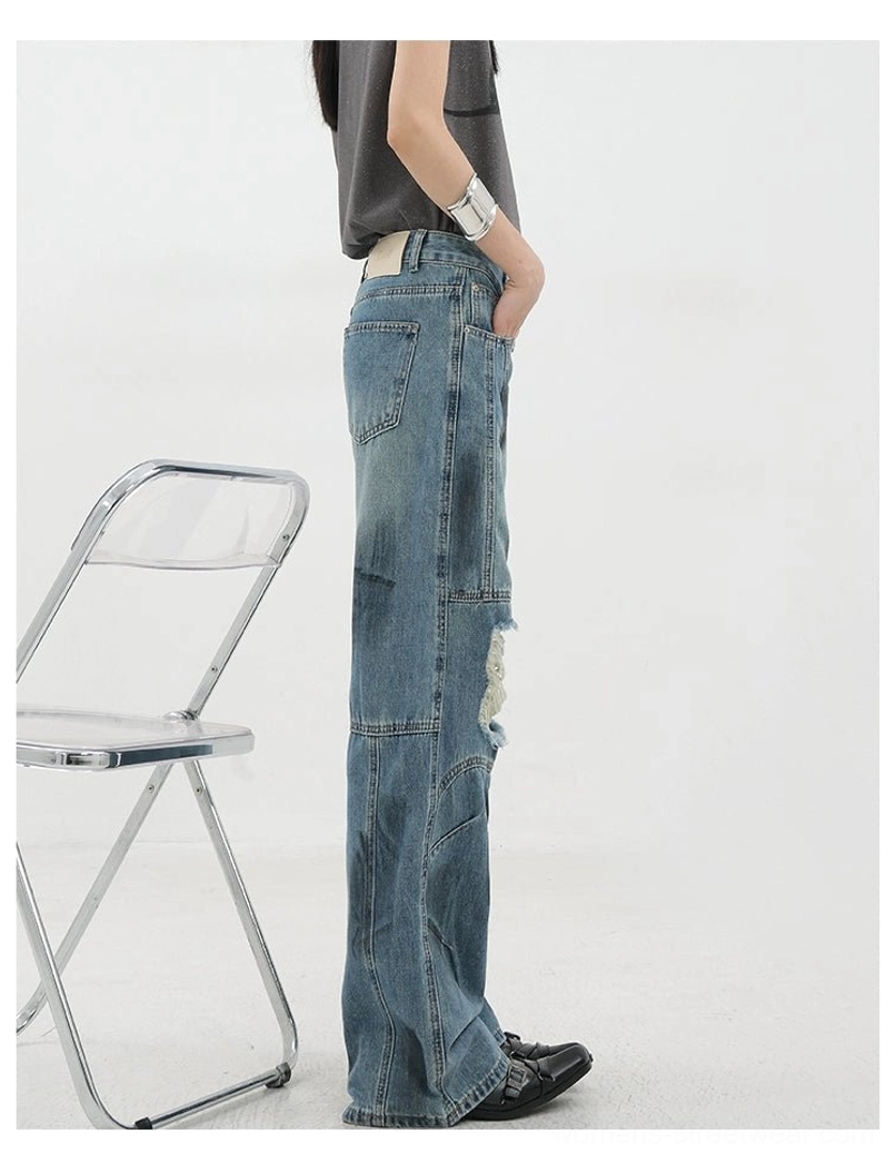 Vintage distressed wide-leg jeans displayed flat lay showing overall silhouette color finish and construction details from neutral photography angle for product documentation