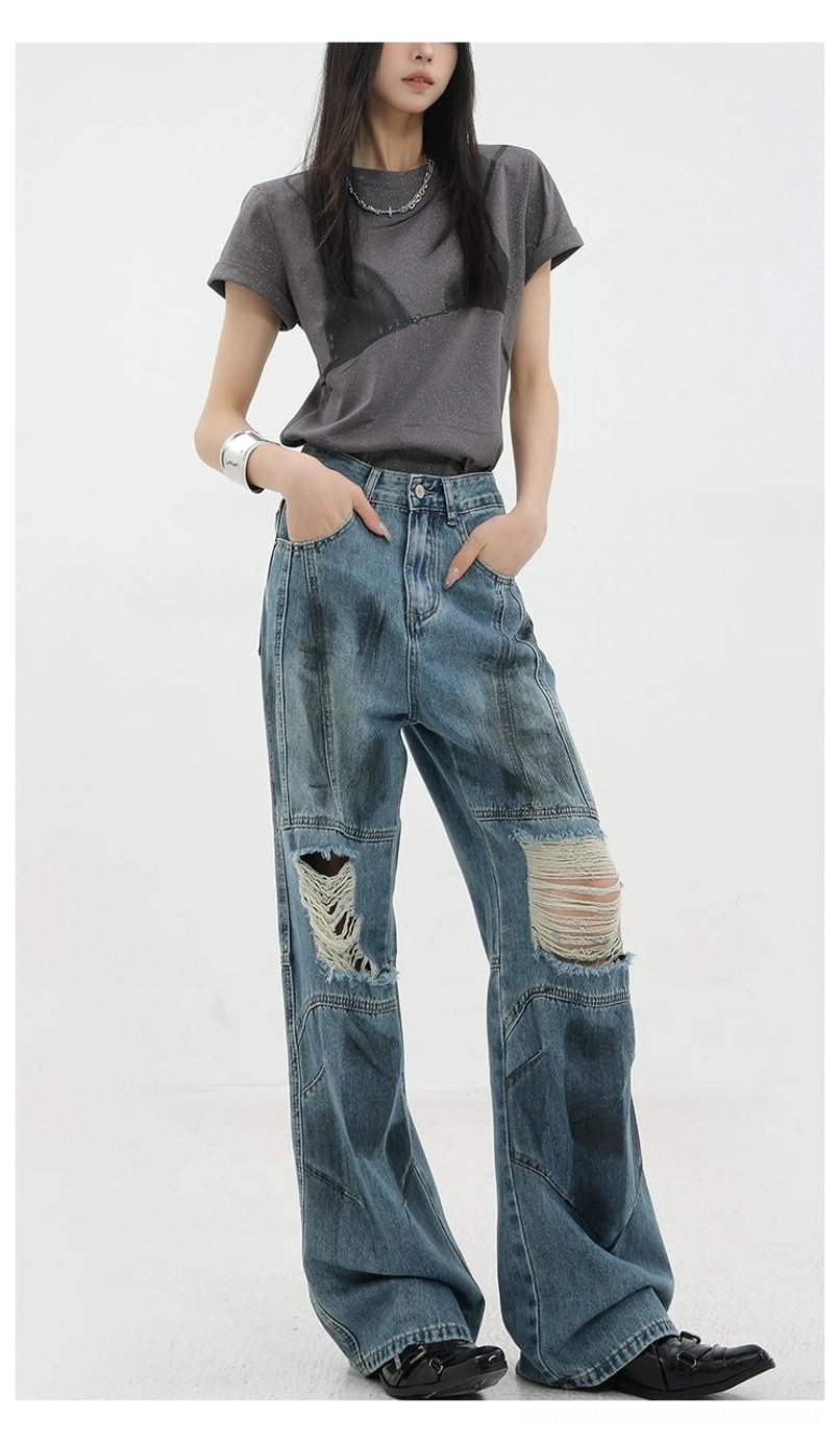 Vintage distressed wide-leg jeans full-length on-model view demonstrating relaxed oversized silhouette and stacking effect over footwear perfect for contemporary streetwear styling