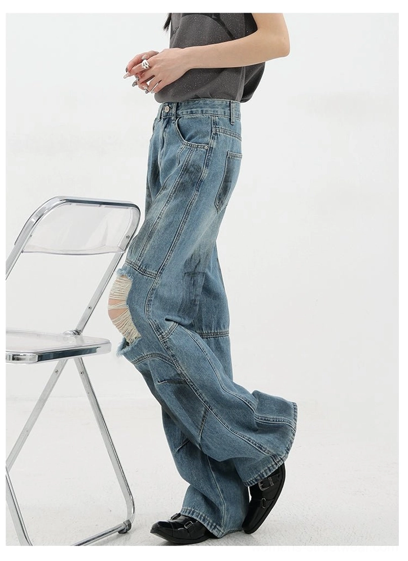 Vintage distressed wide-leg jeans layered with cropped jacket demonstrating versatile styling approach for casual streetwear and high-fashion grunge combinations
