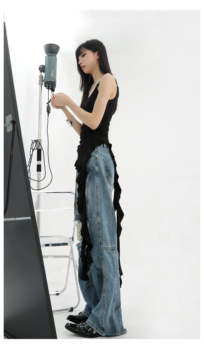 Vintage distressed wide-leg jeans waistband and upper torso detail showing high-rise placement multi-panel seaming and classic five-pocket construction on relaxed silhouette