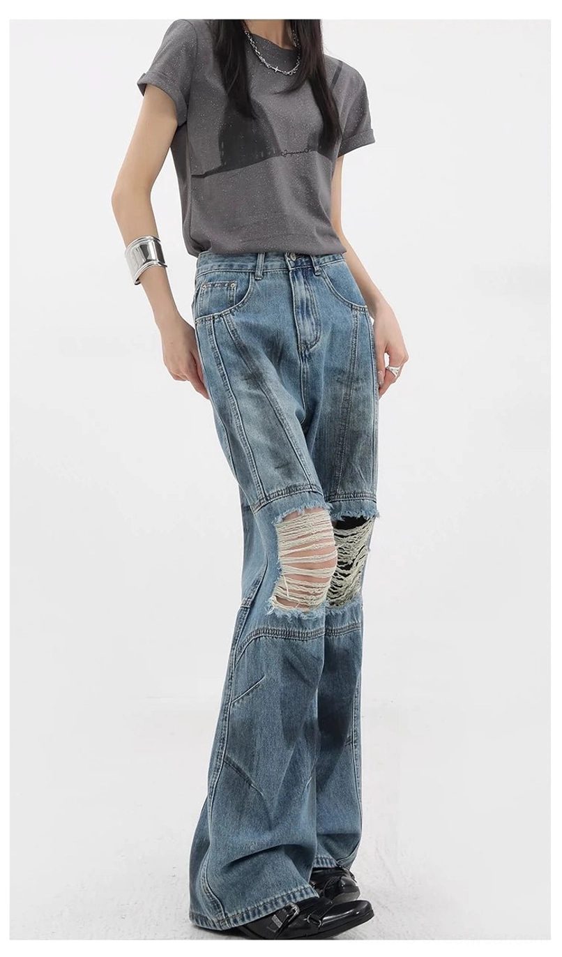 Vintage distressed wide-leg jeans worn-in texture close-up showcasing authentic dirt-dyed finish and naturally faded appearance that develops through careful vintage-inspired production process