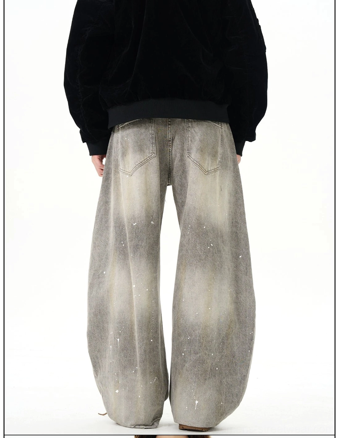 Back view of vintage faded gray paint splatter ultra wide leg denim jeans with classic rear pockets