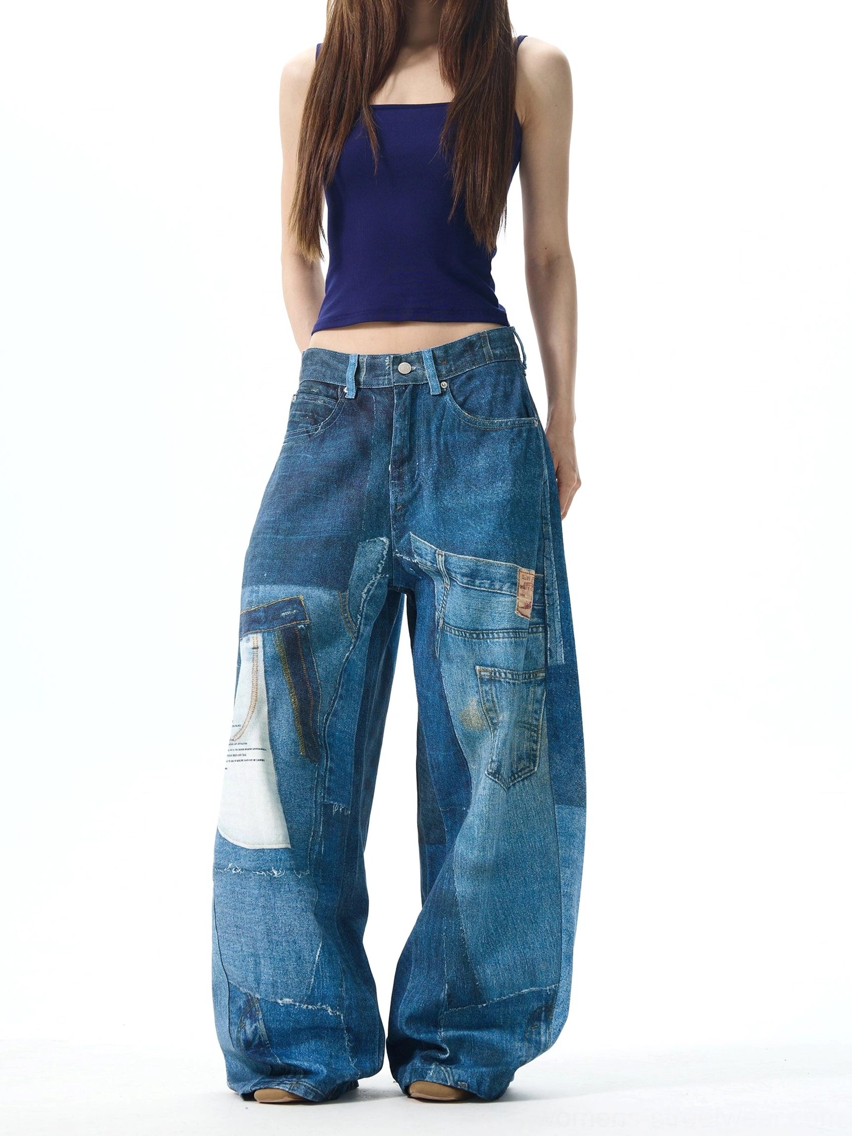 Front view of vintage faded patchwork jeans for women featuring mixed blue denim tones, relaxed oversized trousers, and wide leg streetwear silhouette